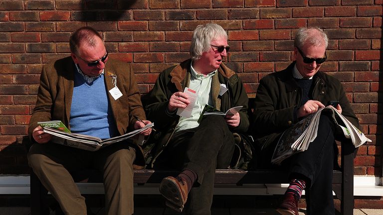 Racegoers study the form ahead at Cheltenham Racecourse
