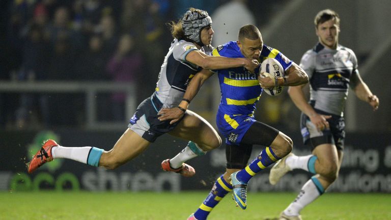 WARRINGTON, ENGLAND - MARCH 13:  Kevin Penny of Warrington Wolves gets past Ashton Golding of Leeds Rhinos on his way to scoring the opening try during the
