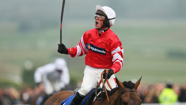 CHELTENHAM, ENGLAND - MARCH 13: Nico de Boinville on Coneygree celebrates winning the Betfred Cheltenham Gold Cup Chase at the Cheltenham Festival at Chelt