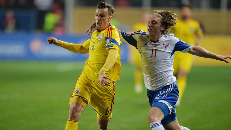 Vlad Chiriches (left) of Romania vies with Joan Edmundsson (right) of Faroe Islands