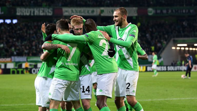 Kevin de Bruyne is mobbed by his team-mates after scoring Wolfsburg's second