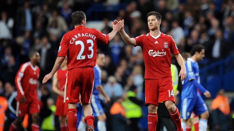LONDON - OCTOBER 26:  Xabi Alonso of Liverpool celebrates with Jamie Carragher of Liverpool after they beat Chelsea at home during the Barclays Premier Lea