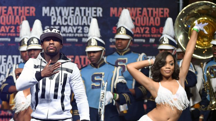 LAS VEGAS, NV - APRIL 28:  WBC/WBA welterweight champion Floyd Mayweather Jr. (L) gestures as he arrives at MGM Grand Garden Arena