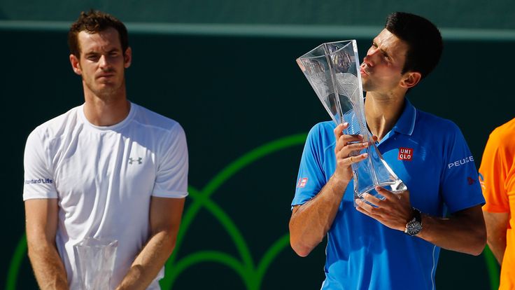 Novak Djokovic with the Miami Open trophy as Andy Murray looks on