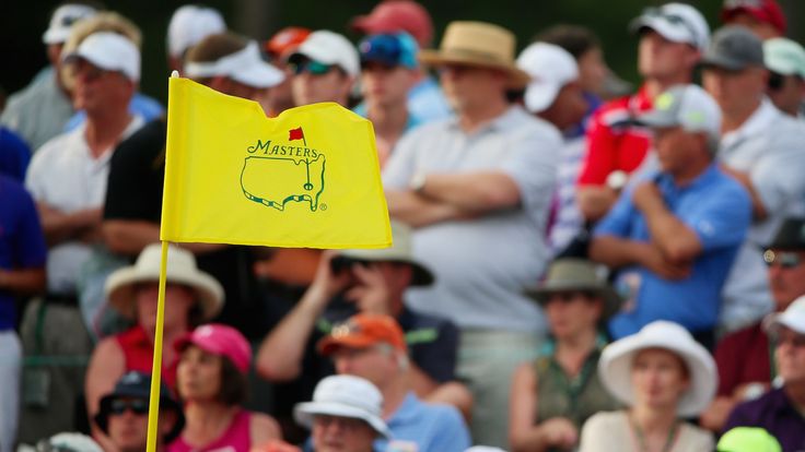 Patrons watch the play during the first round of the 2015 Masters Tournament at Augusta National Golf Club