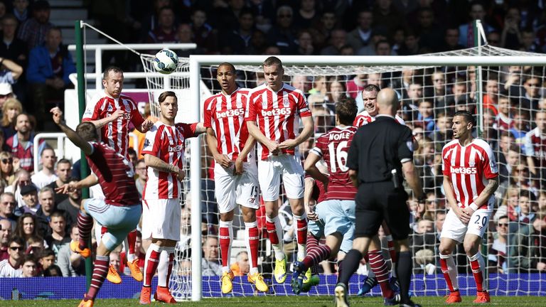West Ham United's English defender Aaron Cresswell (L) scores from this free kick during the match between West Ham United and Stoke City at Upton Park