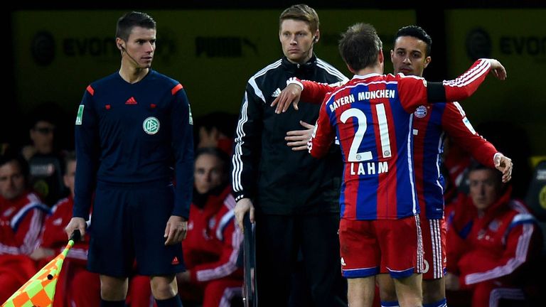Philipp Lahm hugs Thiago Alcantara of Bayern Munich against Borussia Dortmund
