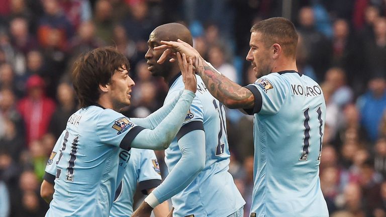 Aleksandar Kolarov celebrates with David Silva after scoring their second goal during the match between Manchester City and Aston Villa