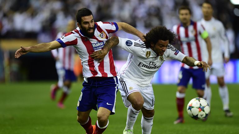 Atletico Madrid's Arda Turan vies with Real Madrid's Brazilian defender Marcelo during the Champions League quarter final Atletico Madrid vs Real Madrid
