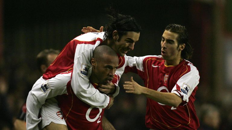Arsenal's Robert Pires (top) and Mathieu Flamini (R) congratulate Thierry Henry after he scored the opening goal against Chelsea in December 204