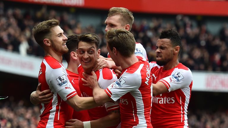 Arsenal's German midfielder Mesut Ozil celebrates with teammates.