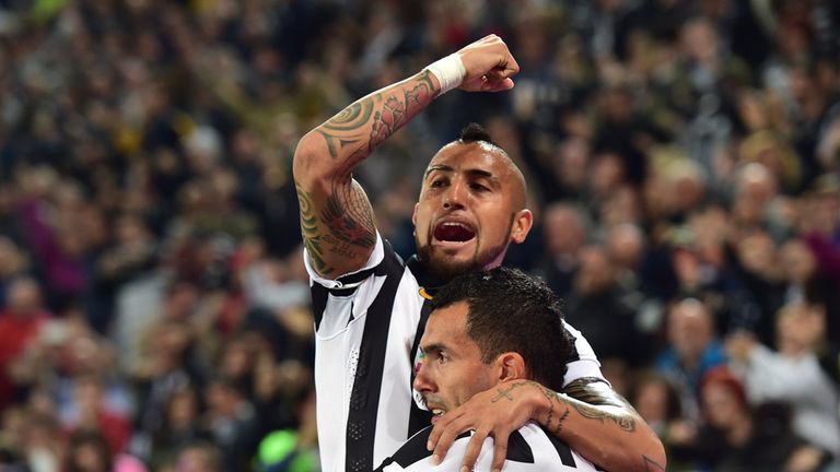 Juventus' forward from Argentina Carlos Tevez (R) celebrates after scoring with Juventus' midfielder from Chile Arturo Vidal
