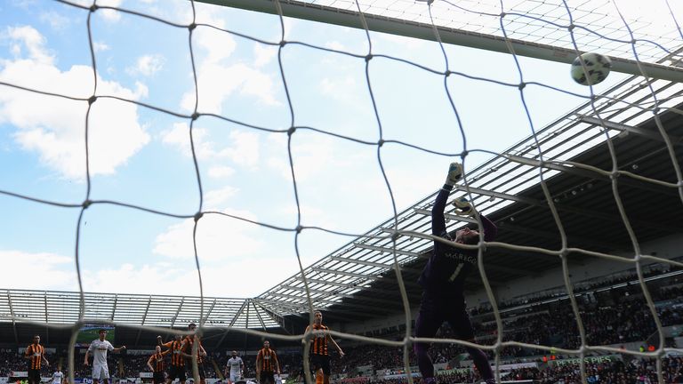 Bafetimbi Gomis of Swansea City scores his team's second goal past Allan McGregor of Hull City at Liberty Stadium
