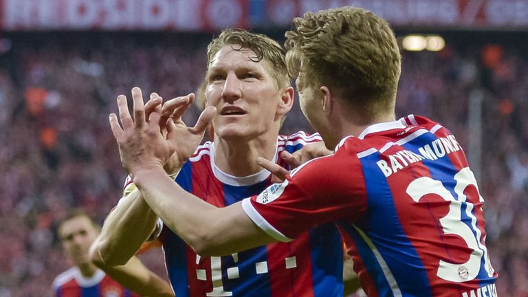 Bayern Munich's German midfielder Bastian Schweinsteiger (L) celebrates scoring the first goal for his team with Bayern Munich's German defender Mitchell 
