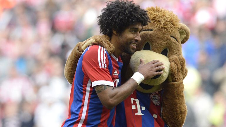 Bayern Munich's Brazilian defender Dante plays with the maskot after during the German first division Bundesliga 
