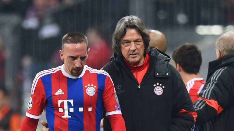 An injured Franck Ribery of Bayern Munich walks with club doctor Hans-Wilhelm Mueller-Wohlfahrt
