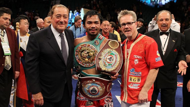 LAS VEGAS - NOVEMBER 14:  (L-R) Promoter Bob Arum, boxer Manny Pacquiao and trainer Freddie Roach celebrate Pacquiao's 12 round TKO victory against Miguel 