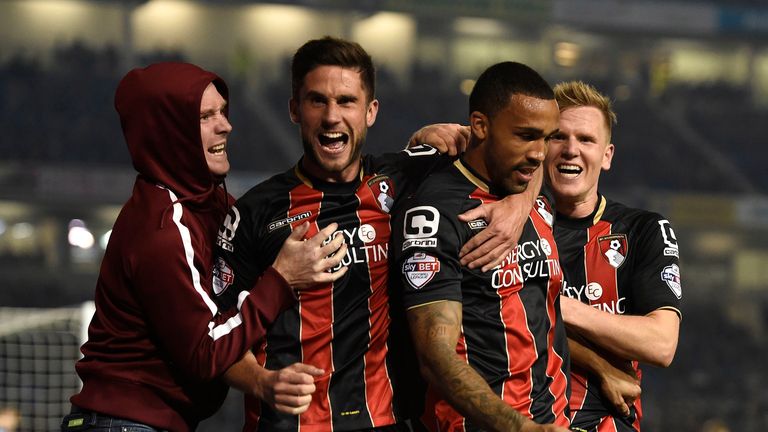 AFC Bournemouth's Callum Wilson (2nd right) celebrates with his team mates Matt Richie (right) and Andrew Surman along with a fan