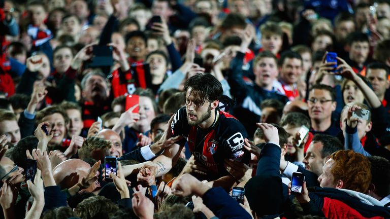Harry Arter of Bournemouth celebrates victory with fans as they invade the pitch after the match between AFC Bournemouth and Bolton Wanderers