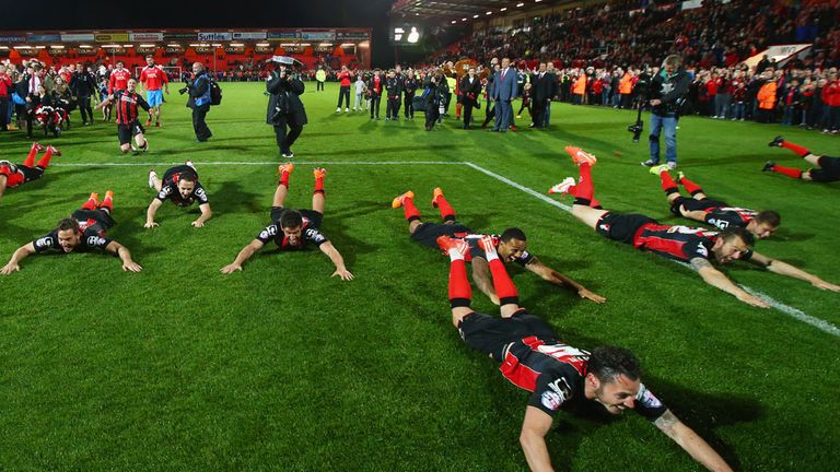 Bournemouth players celebrate promotion with a formation dive