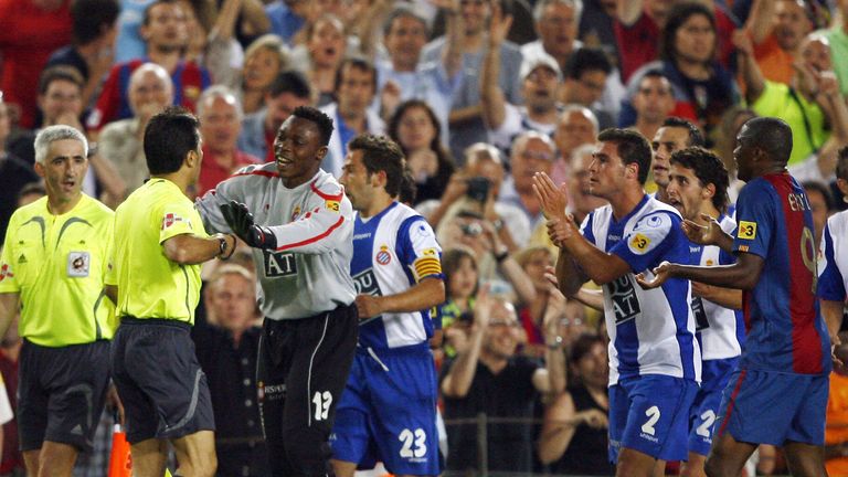 Barcelona, SPAIN: Espanyol players protest against the referee's decision to allow a goal by Barcelona's Lionel Messi which was a hand ball during a Spanis