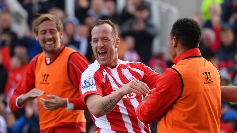 Charlie Adam of Stoke City celebrates scoring their first goal with Peter Crouch and Peter Odemwingie