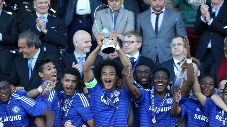 Isaiah Brown of Chelsea lifts the UEFA Youth League trophy