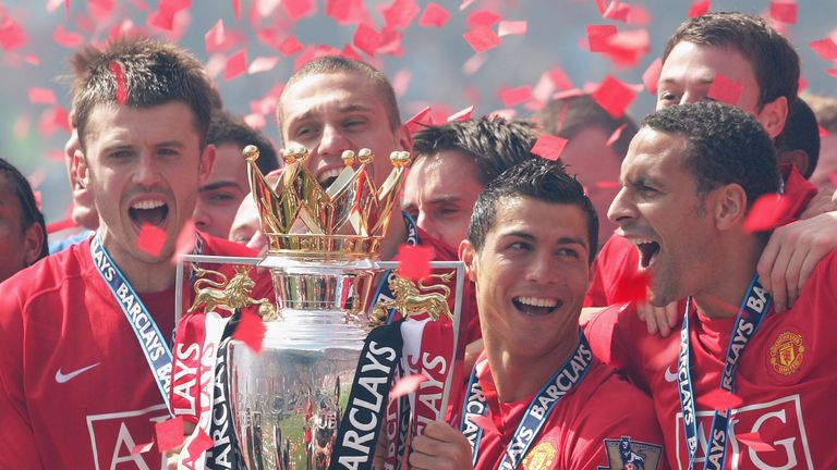 Cristiano Ronaldo of Manchester United celebrates with the Premier League trophy Michael Carrick Rio Ferdinand