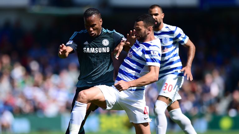 Didier Drogba is tackled by Steven Caulker 