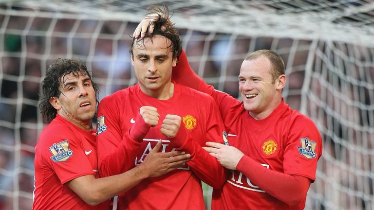 Dimitar Berbatov celebrates with Carlos Tevez and Wayne Rooney after scoring for Manchester United against Tottenham at Old Trafford in April 2009