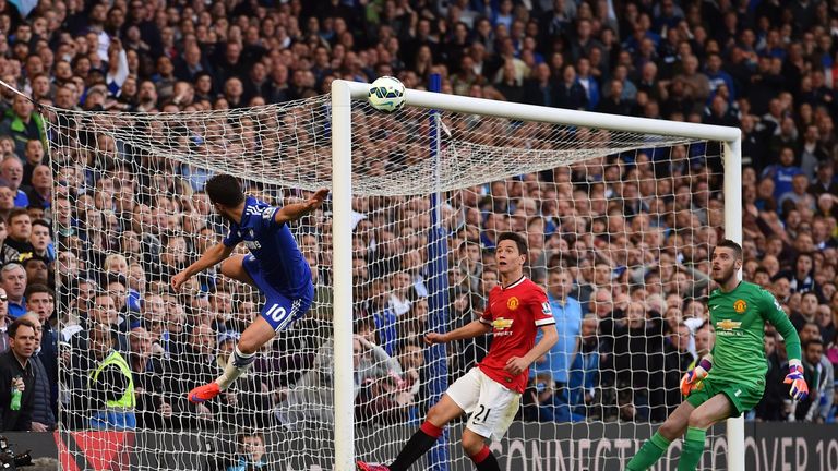 Chelsea's Eden Hazard (L) attempts an acrobatic shot as Manchester United's David de Gea (R) and Ander Herrera (C) eye the ball 