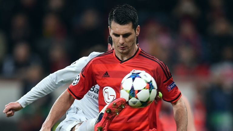 Atletico Madrid's defender Juanfran and Leverkusen's Bosnian defender Emir Spahic (R) vie for the ball