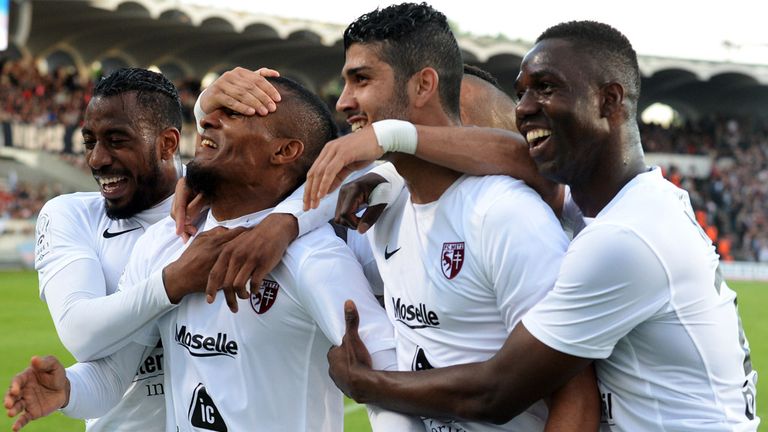 Metz's players celebrate after their Tunisian midfielder Ferjani Sassi (2nd R) scored a goal