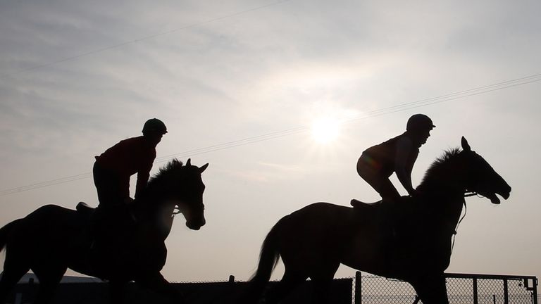 Horses and riders on the gallops early morning, ahead of the Grand Opening Day of the Crabbies Grand National Festival
