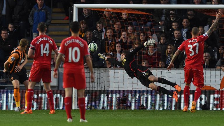 Hull City's English defender Michael Dawson (L) heads the ball past Liverpool's Belgian goalkeeper Simon Mignolet