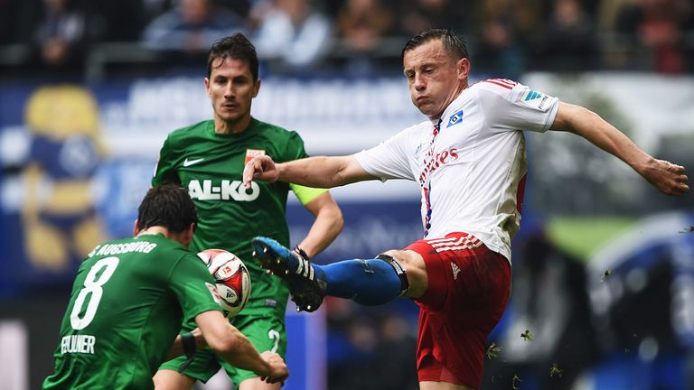 HAMBURG, GERMANY - APRIL 25:  Ivica Olic of Hamburg is challenged by Markus Feulner of Augsburg during the 