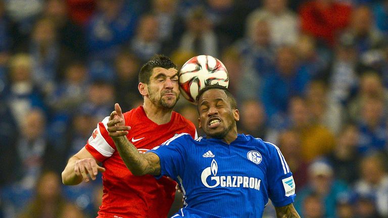 Schalke's Jefferson Farfan (R) vies for the ball with Freiburg's Stefan Mitrovic during the German first division 