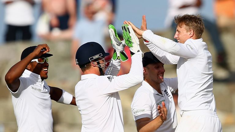 Joe Root (R) of England celebrates taking the wicket of Darren Bravo caught at first slip by Chris Jordan