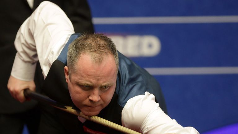  John Higgins of Scotland in action against Robert Milkins of England during day one of the Betfred World Snooker Championship