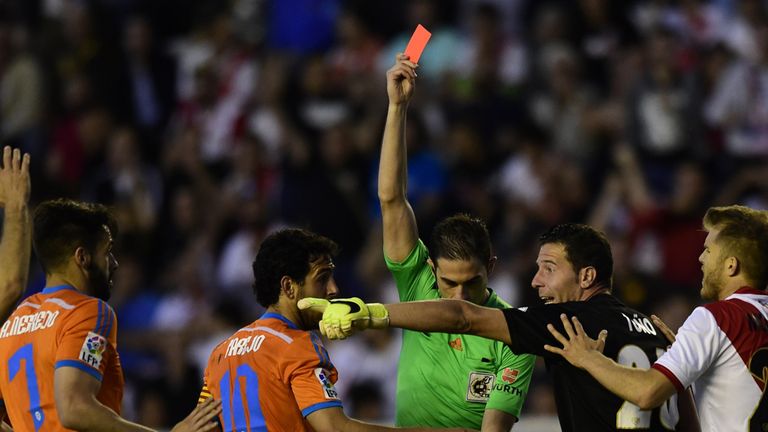 Refeere (C) shows a red card to Rayo Vallecano's defender Jorge Morcillo