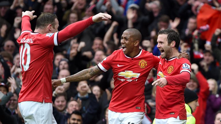 Manchester United's Juan Mata (right) celebrates scoring their third goal of the game with team-mates Ashley Young and Wayne Rooney v Man City