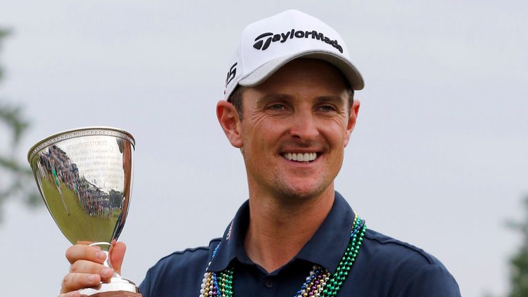Justin Rose, of England, holds the trophy after winning the Zurich Classic PGA golf tournament