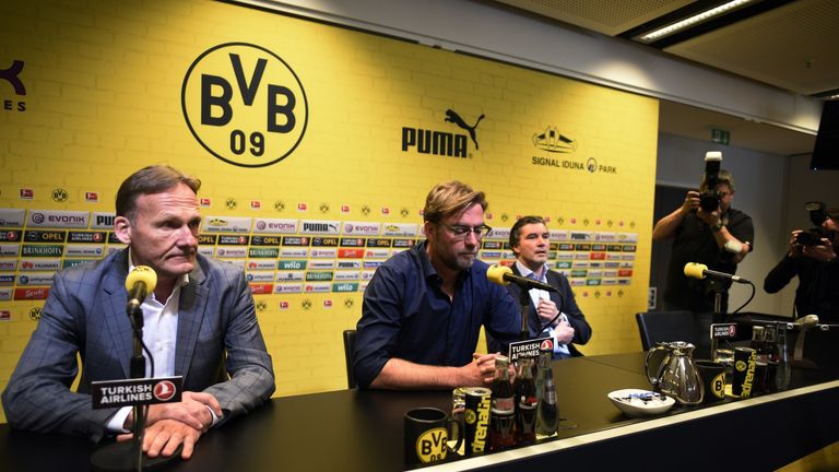 Dortmund's head coach Juergen Klopp (centre) is flanked by  CEO Hans-Joachim Watzke (left) and sports director Michael Zorc (right)