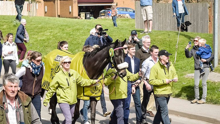 Many Clouds is led towards awaiting crowds to celebrate winning the Crabbies Grand National, during a parade in Lambourn