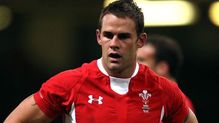 Lee Byrne, wearing a Wales shirt, has ended his rugby career due to injury