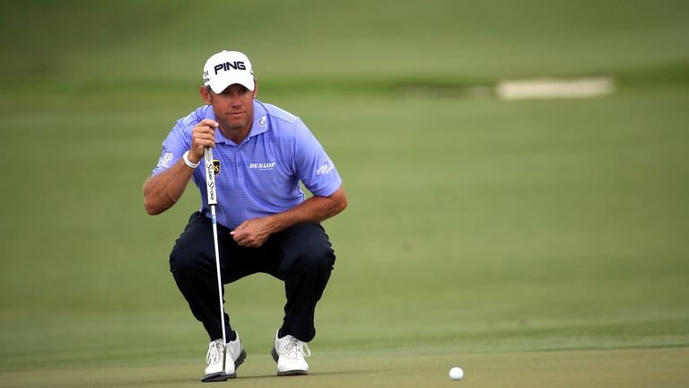Lee Westwood of England lines up his putt on the first hole green during the final round of the World Golf Championships-Cadillac Championship.