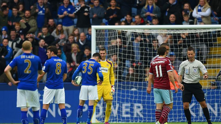 Adrian of West Ham speaks to David Nugent of Leicester City as prepares to take a penalty.