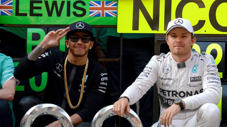 Contrasting emotions: Lewis Hamilton and Nico Rosberg with their trophies post race