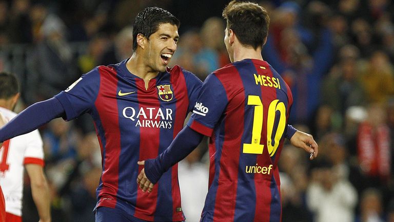 Barcelona forward Luis Suarez celebrates with Lionel Messi