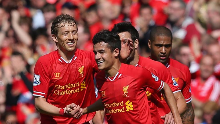 Lucas Leiva (left) congratulates Liverpool teammate Philippe Coutinho (right).